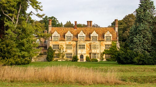 A front-on view of the house at Anglesey Abbey in the autumn